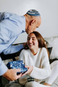 Jewish man kissing daughter